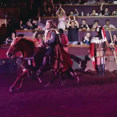 Performer in a king’s costume riding a horse at the Tournament of Kings show