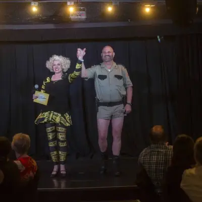 Performer in police costume talking to the audience at the Marriage Can Be Murder Dinner Show