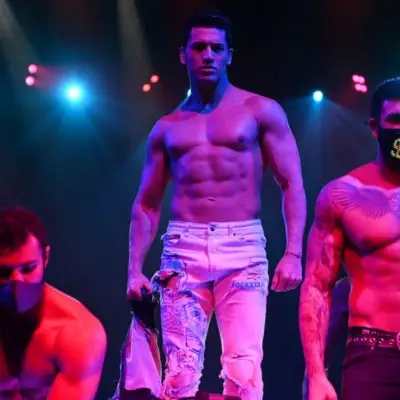 Performers under purple lights in Chippendales, Las Vegas