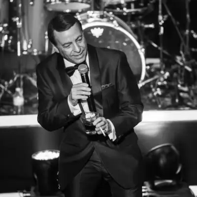 The Frank Sinatra impersonator looking at the audience while singing