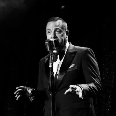 A black and white picture of the artist singing on stage in Las Vegas