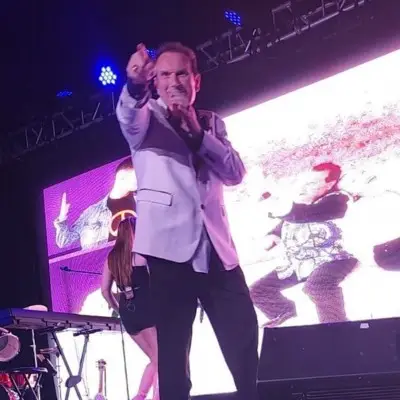 one of the singers from Together We Will Be Okay performing pointing at the audience