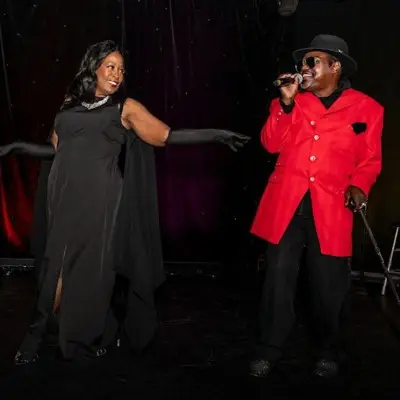 Singers on stage performing at musical journey show with James Brown and Motown