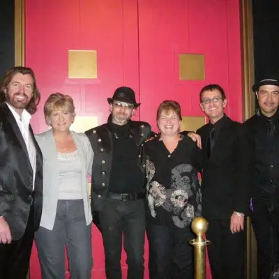 A member of the show posing with fans in Las Vegas