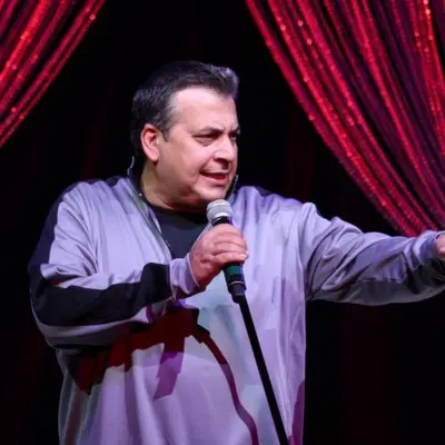 Vinnie Favorito pointing at the audience while delivering his number