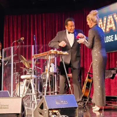 Wayne Newton on stage with a female performer at the Up Close and Personal show